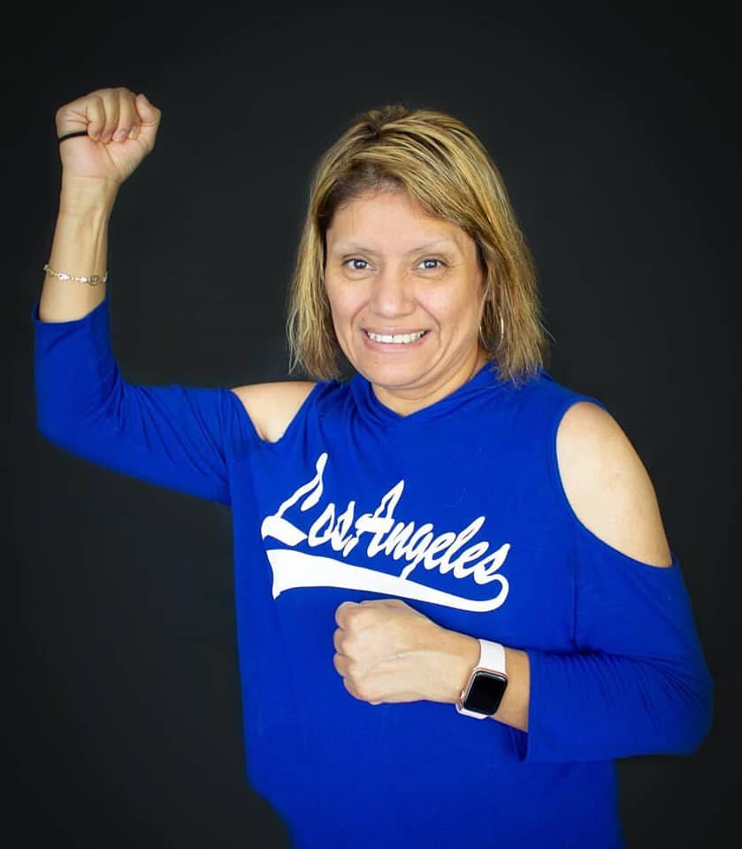 Susie making a power pose for a photo in a 2019 JUST reunion.